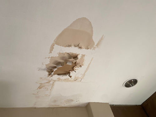 A Broken Ceiling With Dry Wall Water Damage 